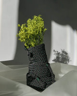 Handbraided black polkadots baskets 3 sizes stacked together elegantly with yellow green flowers arrangement
