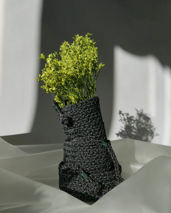 Handbraided black polkadots baskets 3 sizes stacked together elegantly with yellow green flowers arrangement 